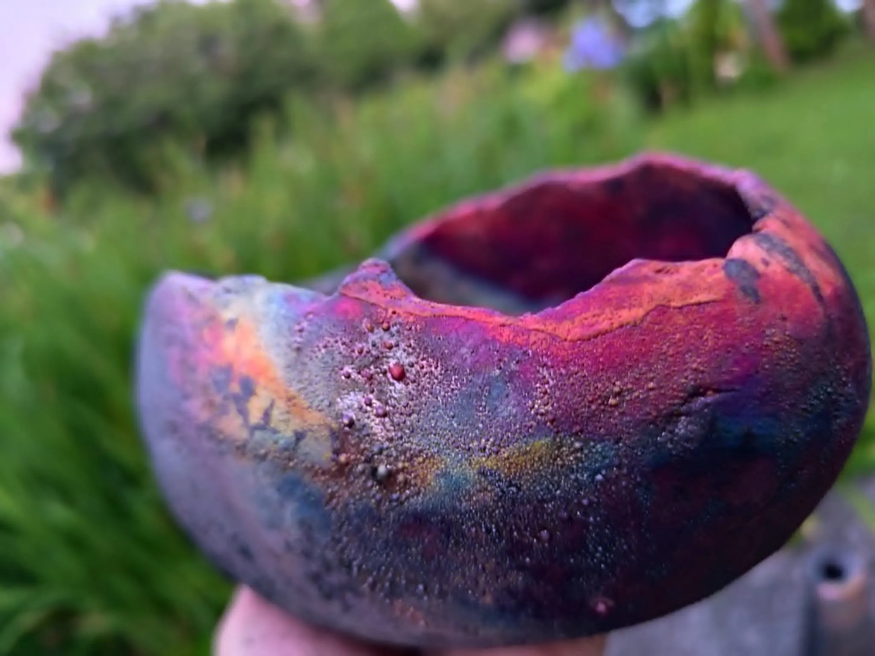 Raku ceramic detail with copper and metallic reflections